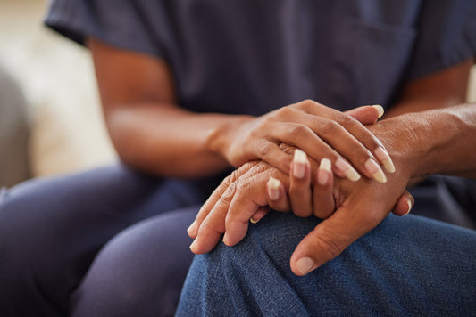 Empath caretaker holding hand of patient